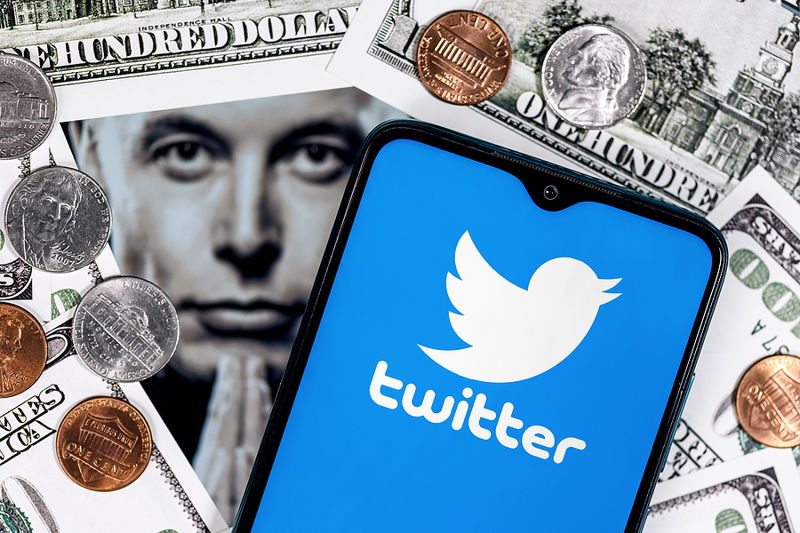 phone with twitter on elon musk and a load of cash